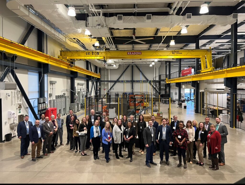Group photo of the attendees in the Mill 19 highbay