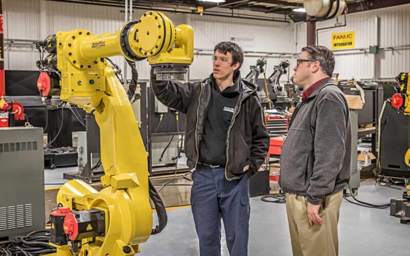Student and Instructor Inspect Robot