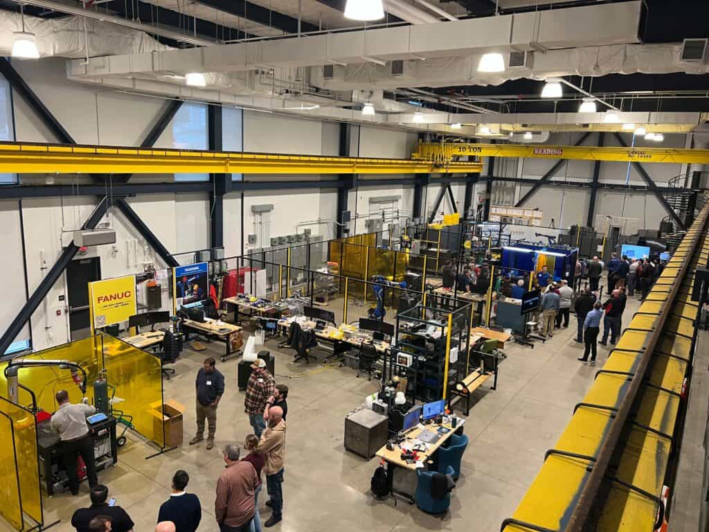 Image showing the ARM Institute's robots in their high bay with people walking around