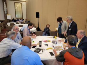 Groups of people convene at tables