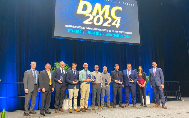 The project team stands on stage with their award