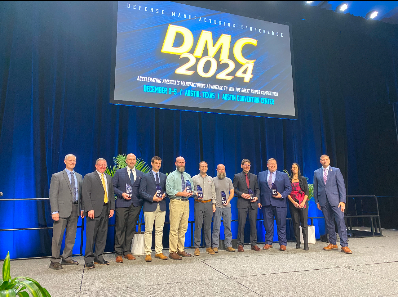 The project team stands on stage with their award