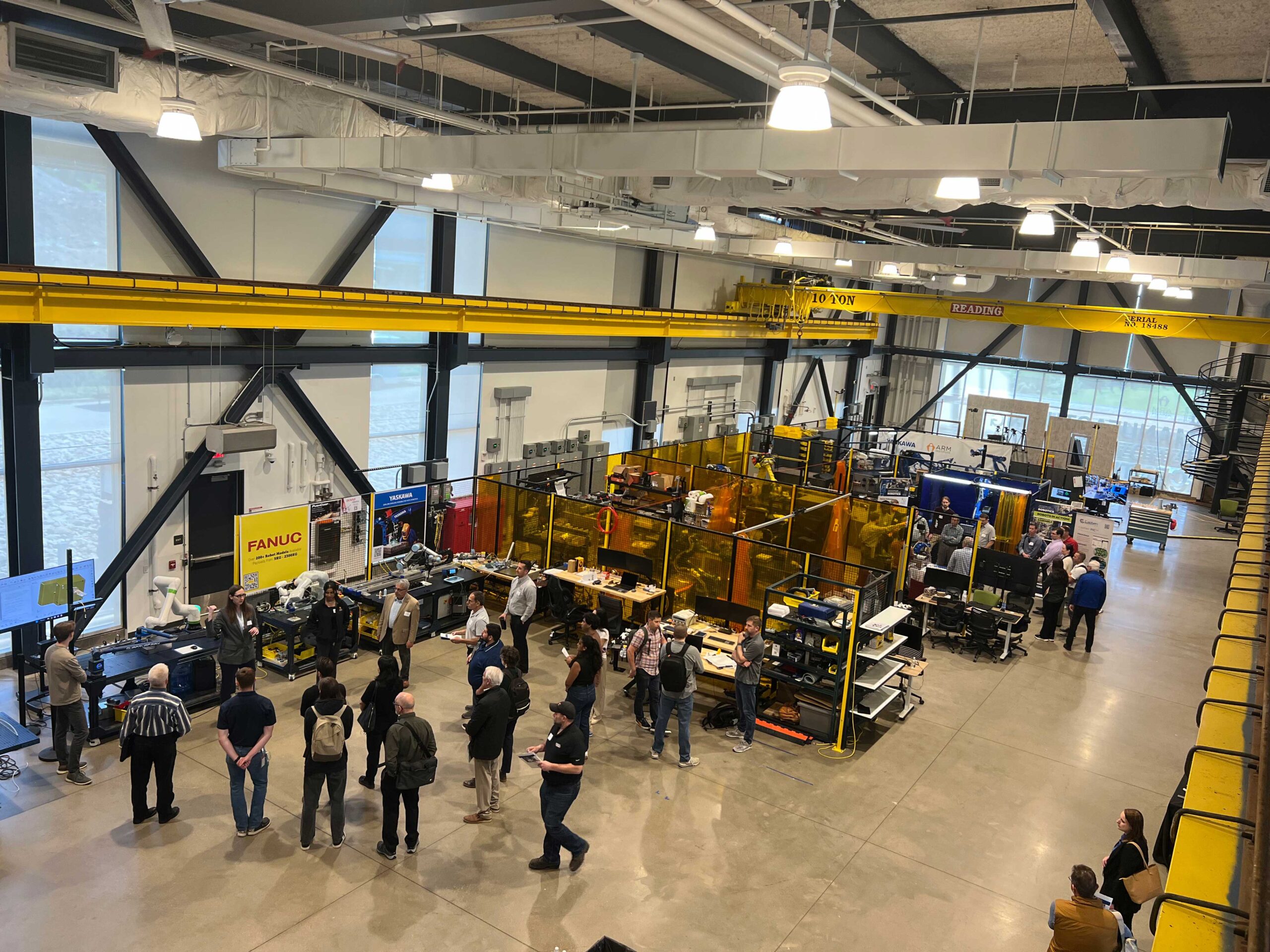 Aerial shot of a workshop showing people gathered around robots