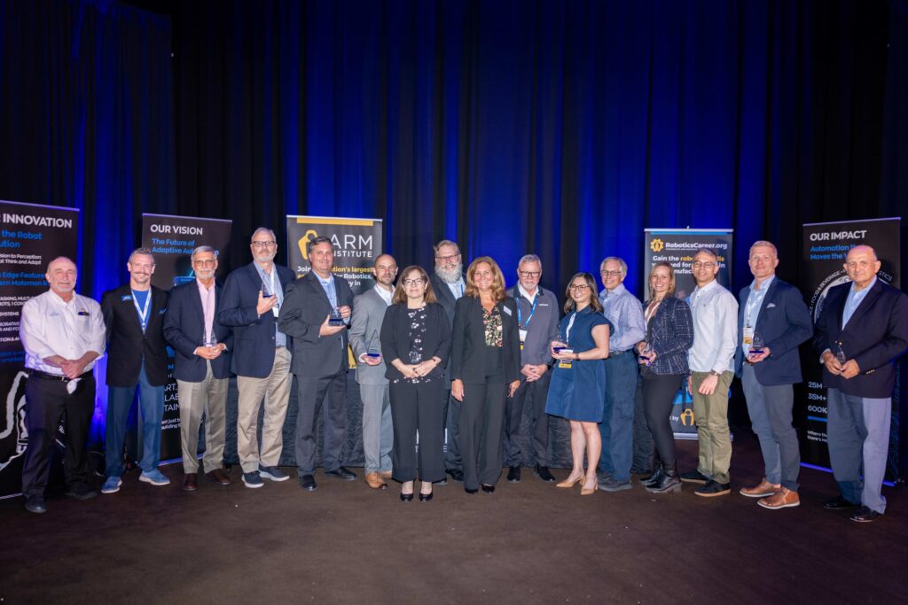 Group photo of the ARM Institute's 2025 class of champions holding trophies