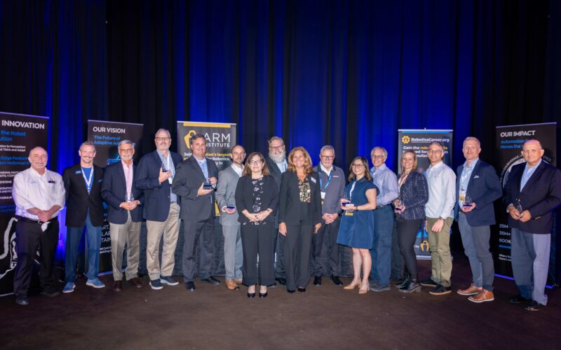 Group photo of the ARM Institute's 2025 class of champions holding trophies