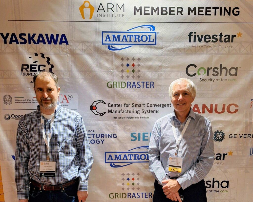 Sponsors from RPI stand in front of our sponsor backdrop
