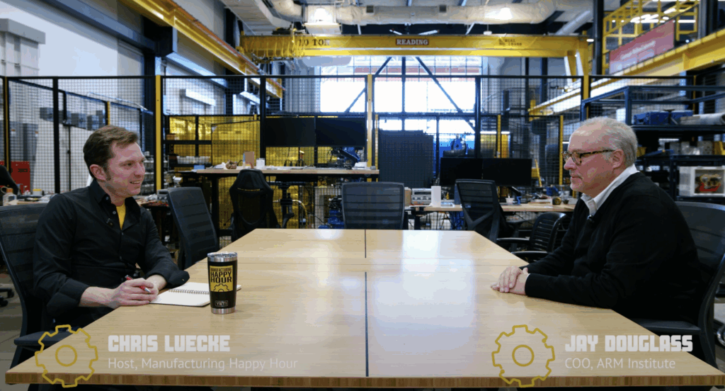 Two individuals sit at a table for an interview