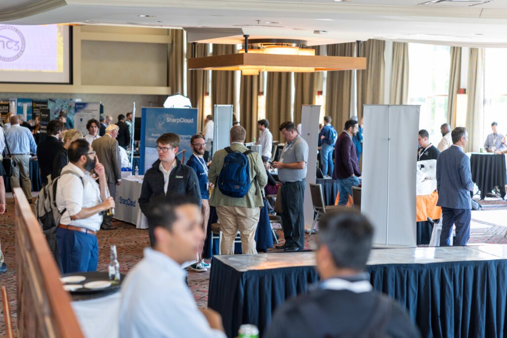 A group of people mingle among tables