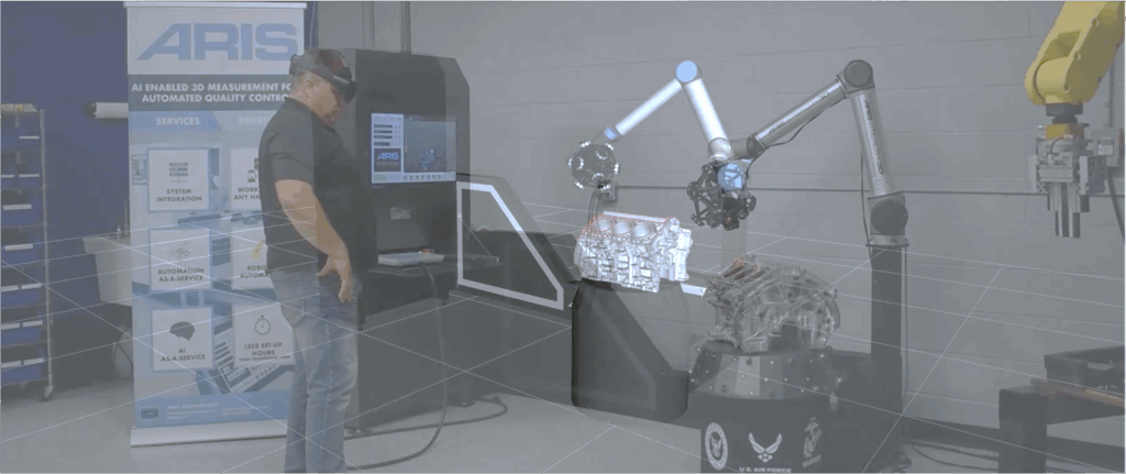 A man operates an ARIS Technology robot